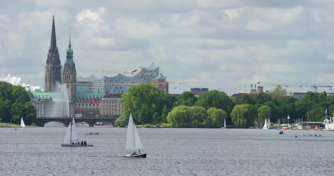Beautiful view of city hall, Elbphilharmonie and Lombard bridge in Hamburg with sailboats in front