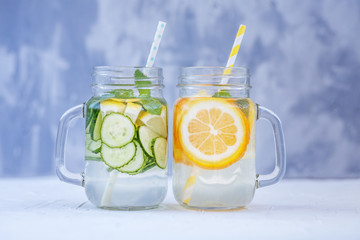 Delicious detox water with cucumber, lemon and mint. Lemonade with orange. The concept of a diet, a...