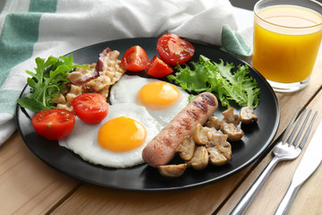 Tasty breakfast with eggs on plate