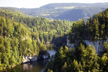 Forest landscape in Switzerland near Les Brenets village with the river Doubs