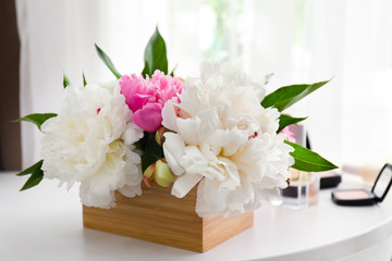 Beautiful bouquet with fragrant peonies on dressing table