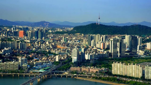 Aerial shot of Seoul City Skyline and N Seoul Tower with traffic bridge, South Korea. 