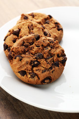 Chocolate cookies on wooden table. Chocolate chip cookies shot
