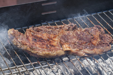 Steak on a grill.