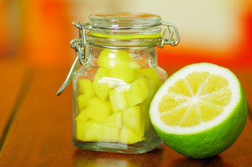 Diced mango in a jar served with lemon