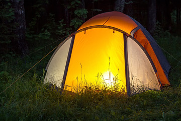 The light burns in the tent at night