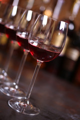 Row of elegant wine glasses with red wine
