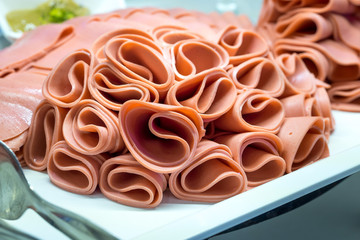 sliced cooked ham on plate buffet share