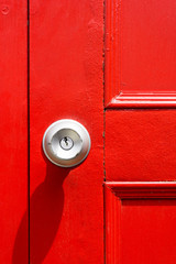 Obraz premium Closeup of knob with red door in vintage.