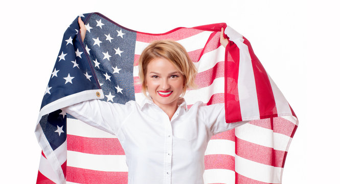 Smiling patriotic woman holding United States flag. USA celebrate 4th July.