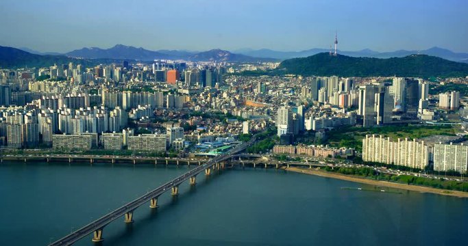 Aerial shot of Seoul City Skyline and N Seoul Tower with traffic bridge, South Korea. 