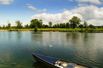 Obraz premium Countryside landscape. River and boat.