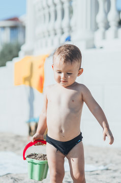 Little boy with pail at the beach