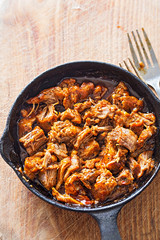 Slow cooked pork on iron skillet 