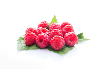 Raspberry fruit with leaf isolated on white.