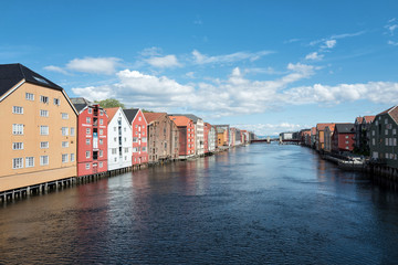 Naklejka premium old storehouses flanking the river Nidelva in Trondheim, Norway