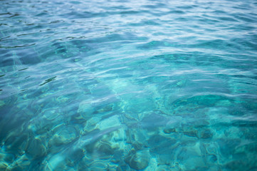 Fototapeta na wymiar Transparent turquoise sea water, natural background. Emerald Coast, Sardinia, Italt.