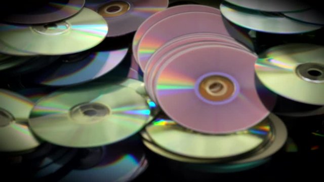 Blured Video Ofcds and Dvds Disk Lie on the Table
