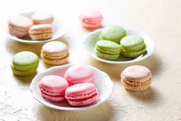 Colourful macaroons on the plates