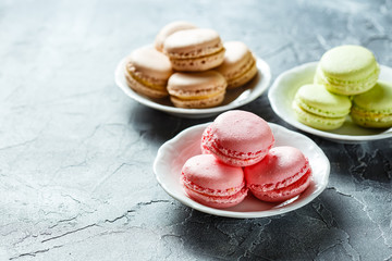 Colourful macaroons on the plates