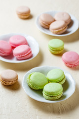 Colourful macaroons on the plates