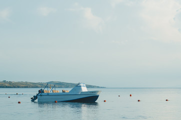 Fototapeta na wymiar empty motor boat stands near the buoys,