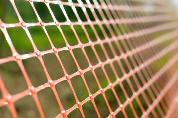 Plastic safety net for construction site. Construction mesh.