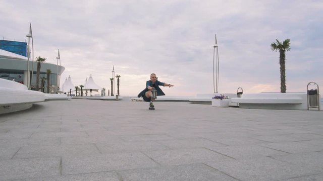 a young caucasian man roller skating with quad skates near the sea, slow motion
