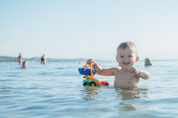 a little boy playing in the sea