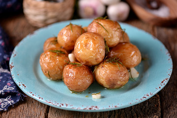 Baked golden whole potatoes with olive oil, rosemary, garlic and sea salt.