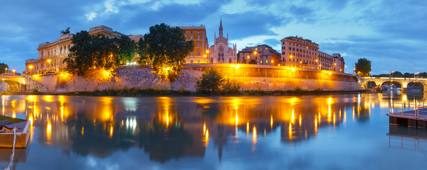 Panoramic view of Tiber riverside with Church of the Sacred Heart of Jesus in Prati and mirror reflection during evening blue hour in Rome, Italy