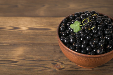 Black currant on a wooden background