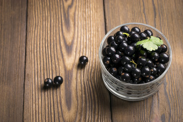Black currant on a wooden background