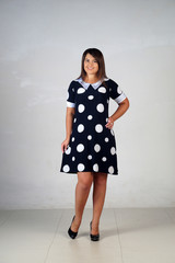 Beautiful young girl  posing on a grey background