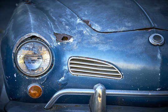Vintage weathered unrestored blue German classic car with rust hole and tons of character
