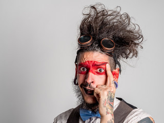 Portrait of a theatrical actor laughing with a mime make-up and a piercing in his nose - 162011780