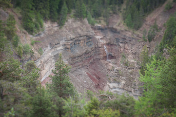 Tilt shift effect of waterfall in red sandstones, Bletterbach canyon, Dolomites, Italy