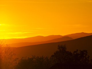 Landscape of mountains at sunset with orange sky in Spain