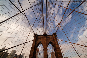 Brooklyn Bridge: symmetrical view of tower arches, cables, and sky above