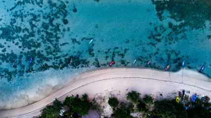 Aerial top view of clear blue sea in summer time on the tropical island 