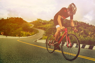 Fototapeta na wymiar Asian man is cycling road bike in the morning