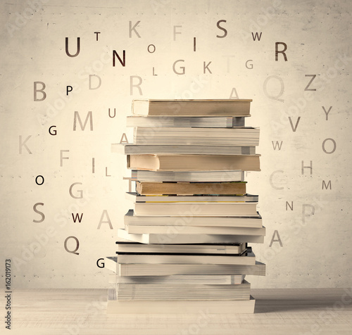 Books With Flying Letters On Vintage Background Stock Photo And