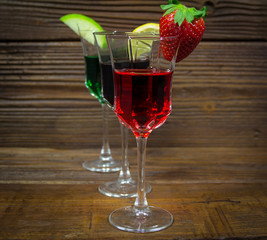 Cocktails fruity alcoholic drinks in glasses on wooden background