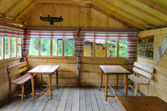 Old Ukrainian style pavilion with wooden tables and benches