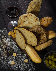 Wine snack set. Glass of red wine, olives,and bread