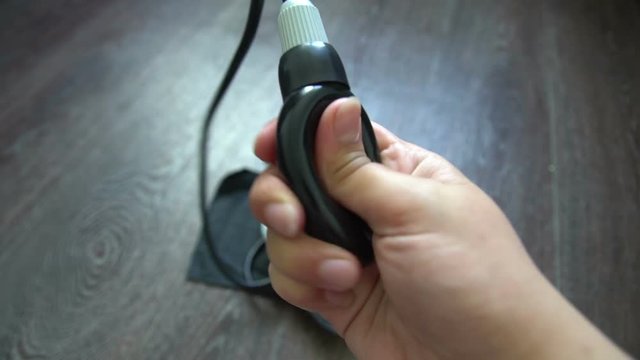 Female Hand Pumping up Tonometer Heartbeat