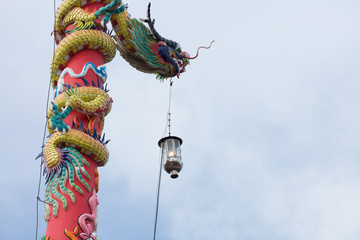 dragon statue on pillar with light lantern