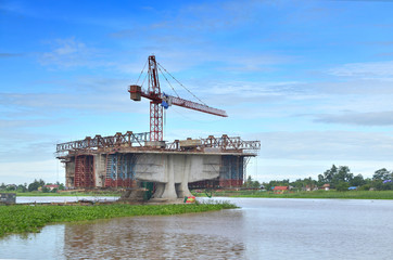 Fototapeta premium Construction of bridges over the river