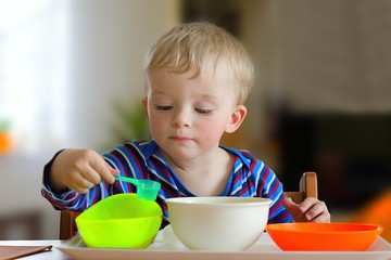 Toddler playing with water bowl activity