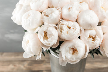 White peonies in vase. retro styled photo. close-up